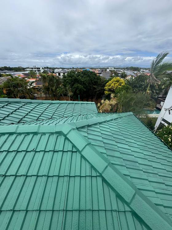 A green tile roof looking out over the street