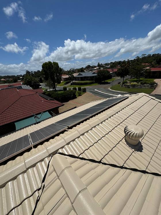 A cream tile roof with a roof vent