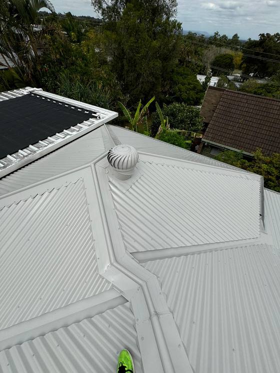 A white tile roof and vent after restoration