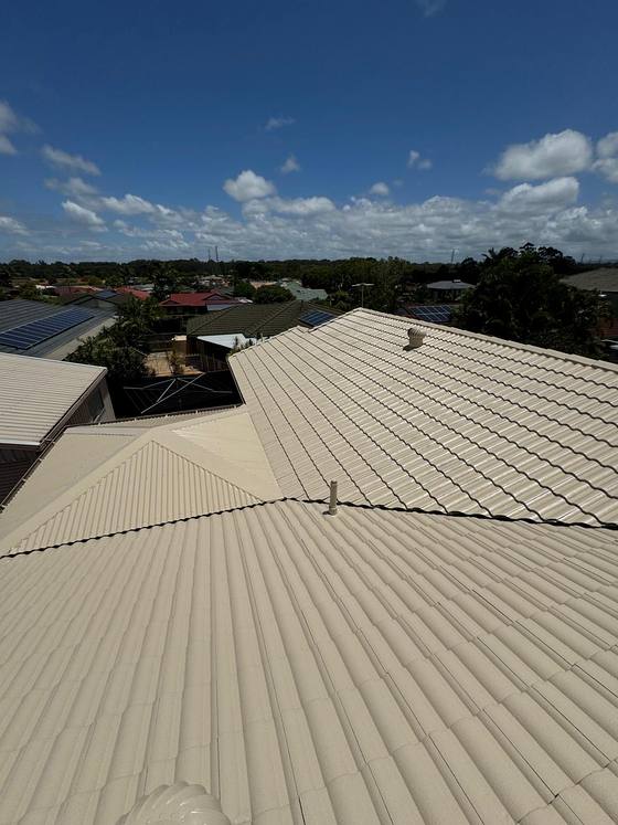 A cream tile roof across a wide hip