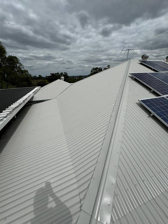 A cream metal roof with solar panels